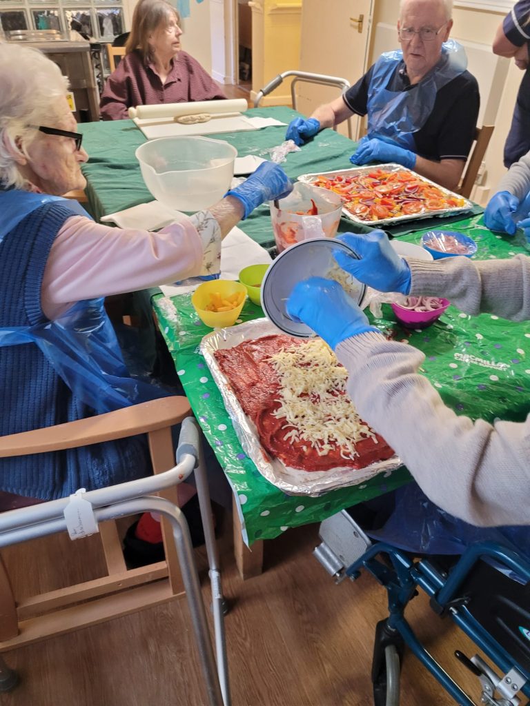 The residents making a make pizza dough from the basic ingredients.